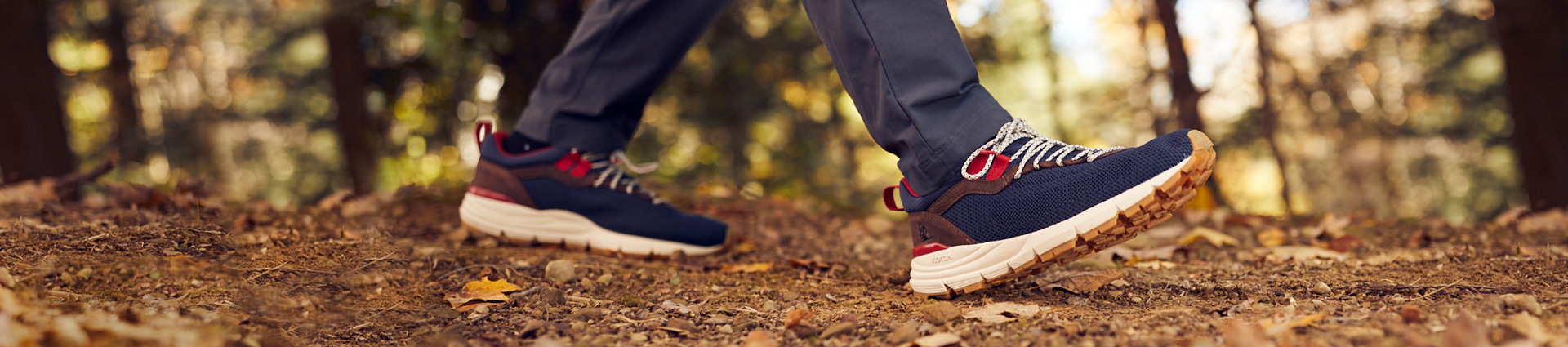 hiker walking down trail in rocky rugged at outdoor shoes